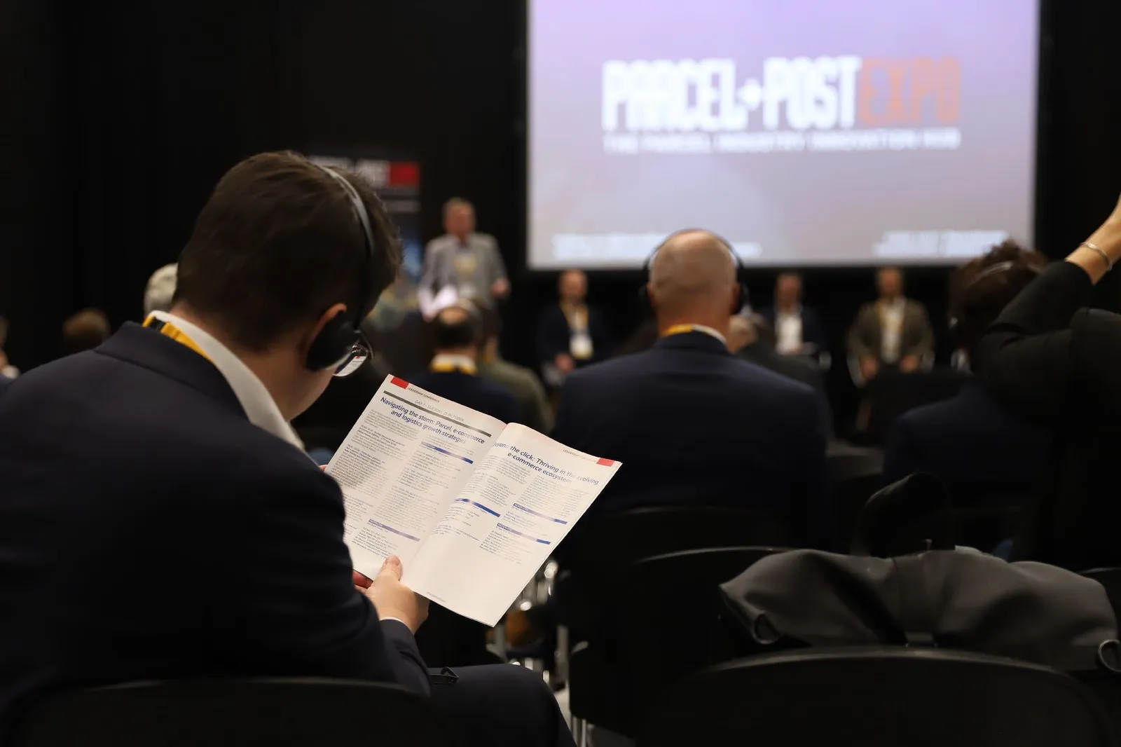 Attendees at a Parcel+Post Expo conference session