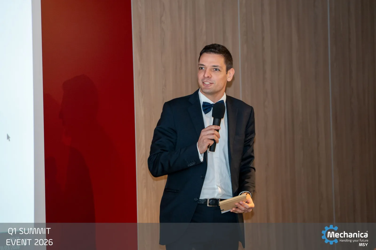 Host opening the Q1 Summit Event on stage