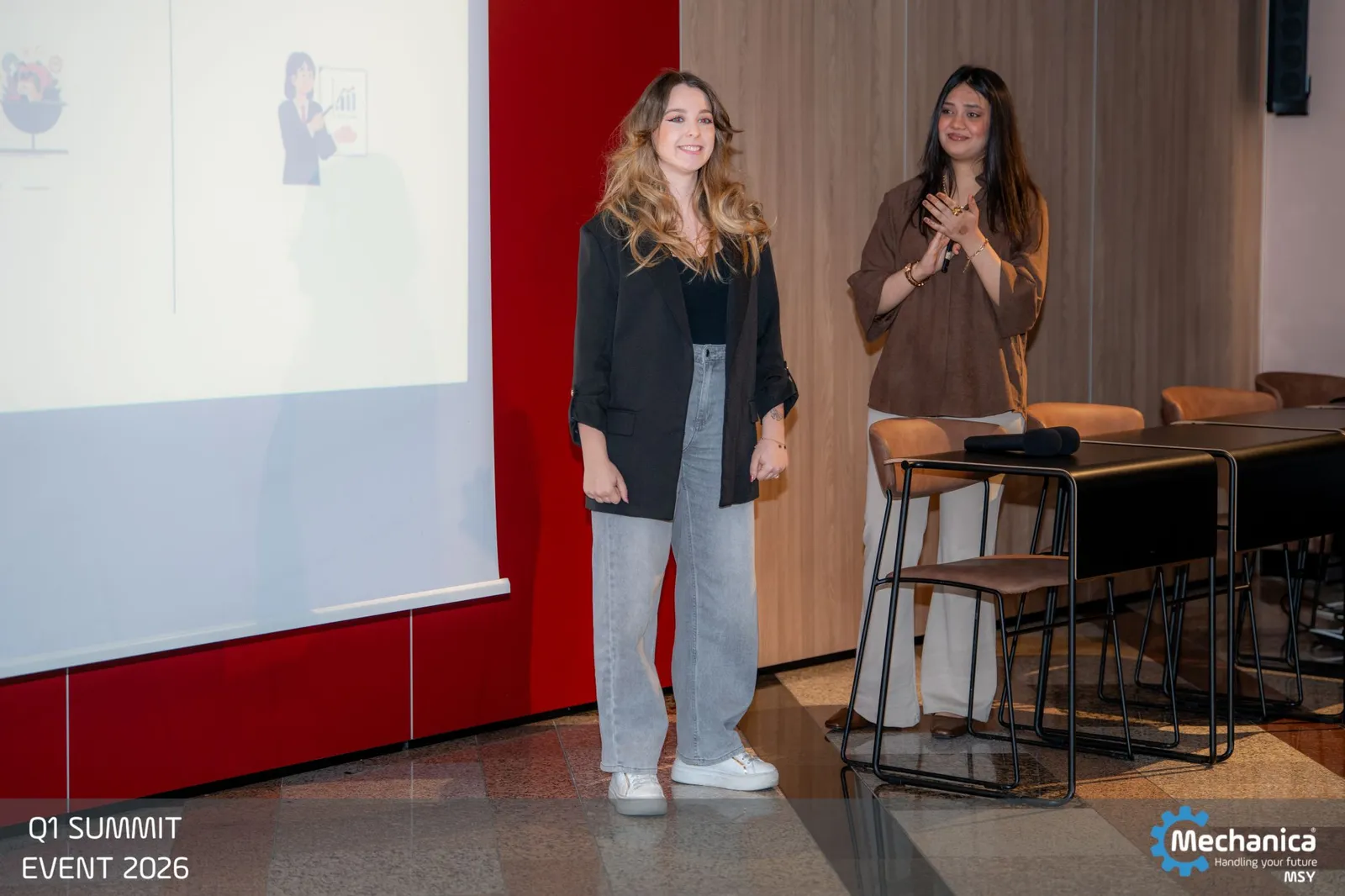 Two colleagues presenting their department's quarter