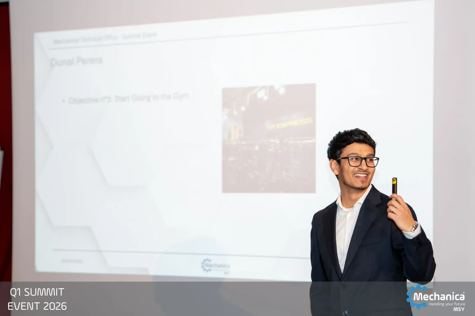 Technical office presentation with yearly objectives on screen