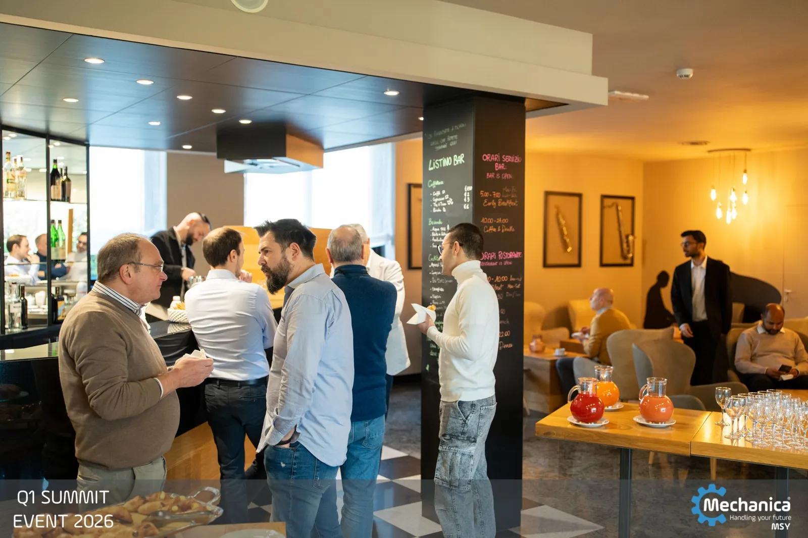Colleagues mingling at the coffee bar between sessions